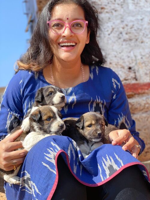 Caregiver with rescued puppies